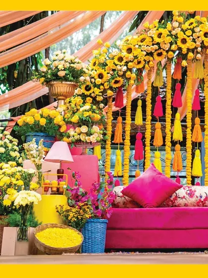 Mehendi ceremonies are all about joy and color. For this celebration, I designed a vibrant setting with a comfortable pink settee, set against a backdrop of bright marigold garlands and playful tassels, creating the perfect atmosphere for fun and festivity.