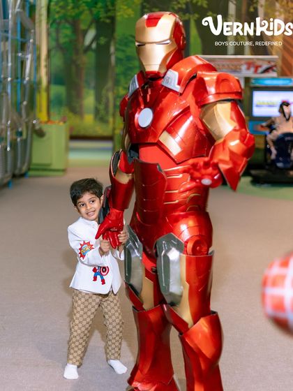 Standing tall next to Iron Man. Our custom-themed jackets are perfect for bringing birthday party themes to life, creating magical moments he'll always remember.