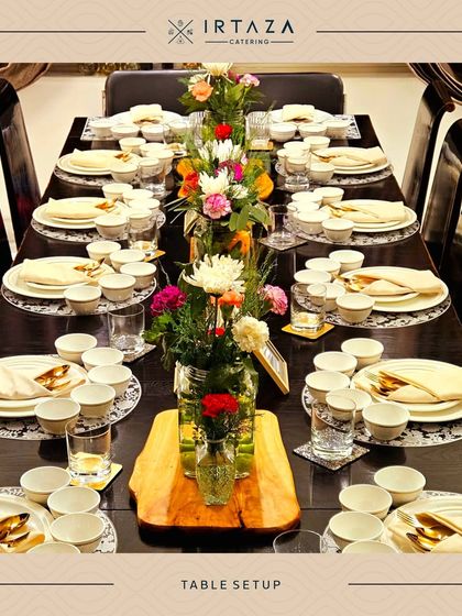 An example of a formal sit-down table arrangement. Each place is meticulously set to create a sophisticated and welcoming dining experience for every guest.