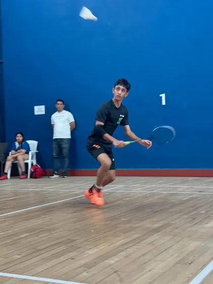 Zehn Masani perfecting his form during a practice session. The focus here is on explosive movement and precise shuttle control, key elements for an attacking player.