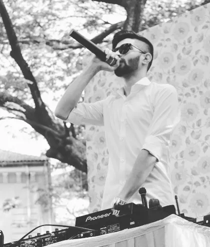 On the mic during a baraat, getting the crowd pumped up. I don't just play music; I lead the energy and make sure the groom's entrance is unforgettable.