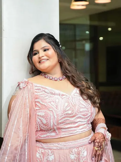 A happy, smiling close-up of the bride, her soft makeup and loose curls creating a romantic engagement look.