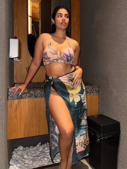 A quick touch-up before heading out. This tropical print bikini and sarong set is perfect for a spa day or lounging by the pool.