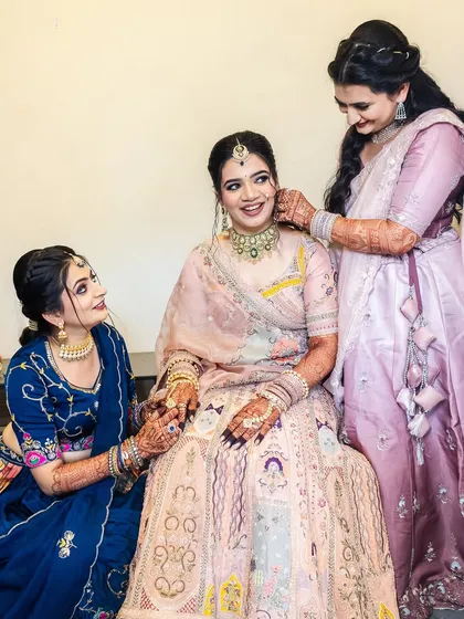 Sisters and friends helping the bride with her final touches.