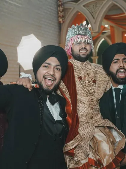 The groom celebrating with his friends during the baraat. The energy and joy in this photo are palpable, capturing the true spirit of a big fat Indian wedding.