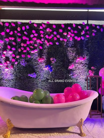 Another view of the bathtub photo booth, showing the colorful balloon clusters on either side that frame the shot perfectly.