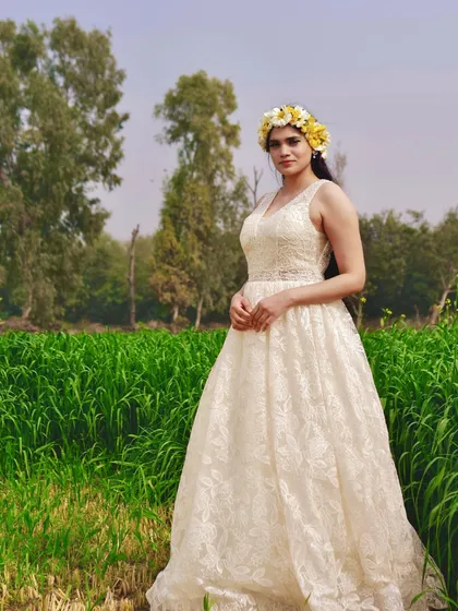 This full-length view showcases the beautiful texture and silhouette of the custom lace gown. It's a versatile piece that can be styled for a bohemian, rustic, or classic pre-wedding photoshoot.