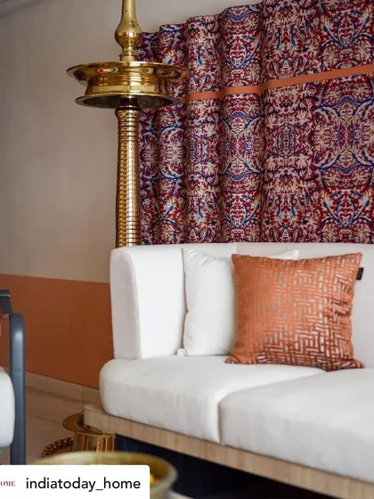 A close-up of the custom Kalamkari art piece, which serves as a stunning backdrop for the sofa. The rich colors and intricate patterns are a nod to the client's South Indian heritage.