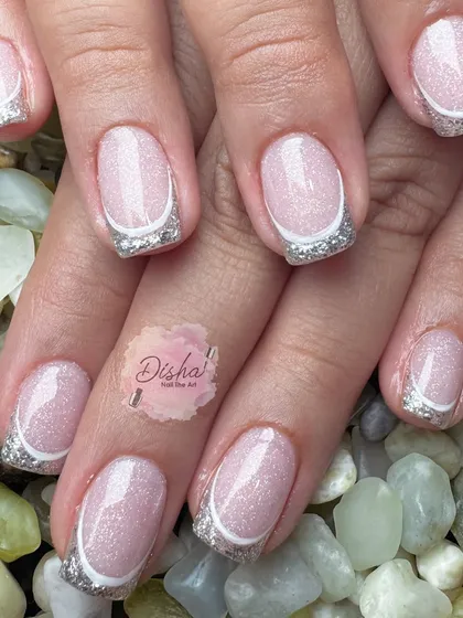 The silver lining. This manicure screams sophistication with its shimmery pink base and sparkling silver French tips.