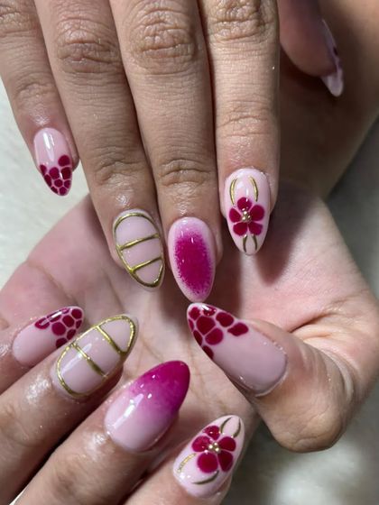 Another shot of the detailed flower nail art. The combination of different techniques like ombre, line work, and painting shows a high level of skill.