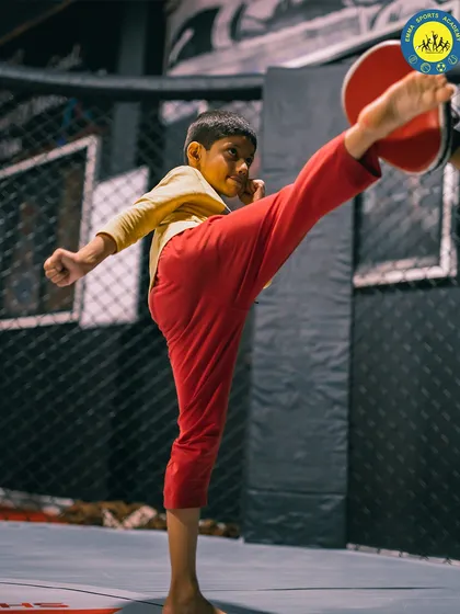 Fierce and focused. A young athlete executes a high kick during a training session, demonstrating incredible flexibility and power.