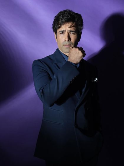 A close-up from the purple series, with a pensive pose that adds to the mysterious and cinematic feel of the shot.