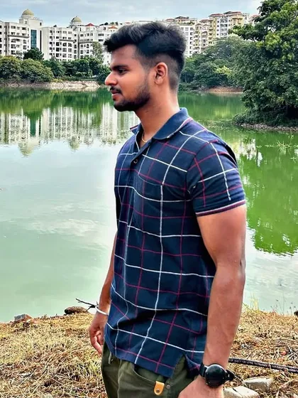 A side profile shot capturing a moment of reflection by the water.
