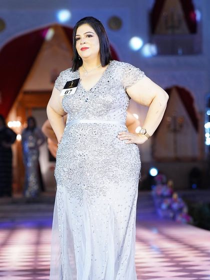The silver sequined plus-size gown with cap sleeves, looking absolutely radiant on the runway.