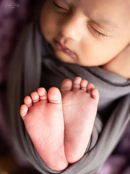 A close up of tiny, perfect toes. I believe every detail is part of your baby's story, and I make sure to capture these small features that you'll want to remember forever. This is a classic shot in my newborn photography sessions.