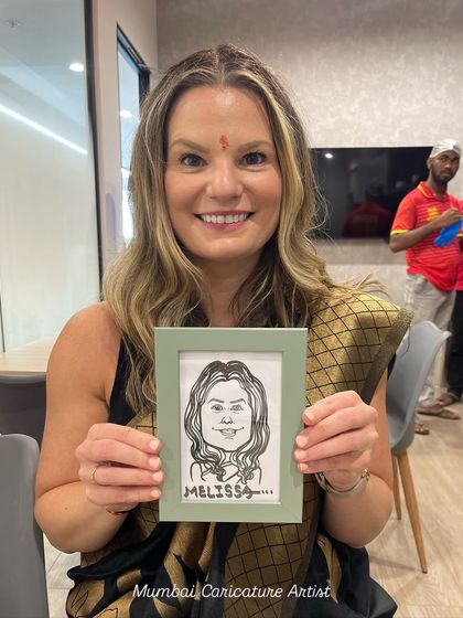 This international guest from a corporate event in Mumbai was thrilled with her caricature, which we presented in a nice frame.