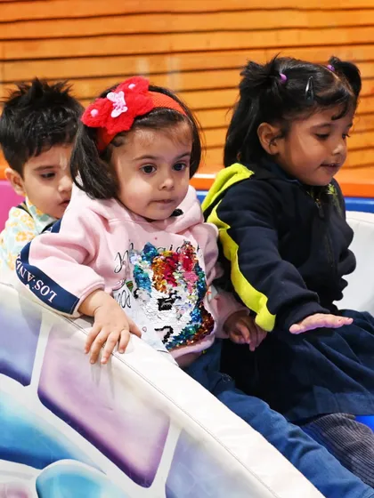 Three toddlers enjoying the small slide together. My Burrow is designed to encourage parallel play and social interaction.