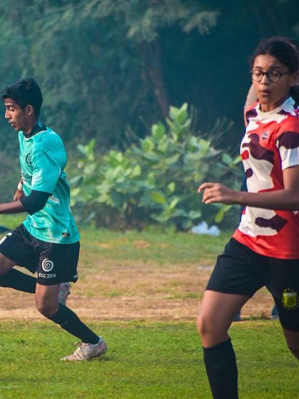 A female player runs alongside a male player, demonstrating the co-ed and inclusive nature of our tournaments.