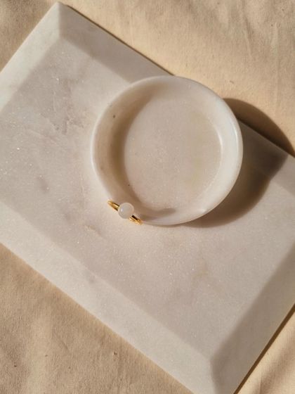 A simple, elegant shot of the White Moonstone Mood Ring, a perfect talisman for luck and abundance.