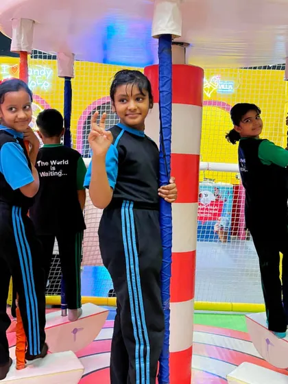 Students enjoying the mini carousel in our soft play zone, a perfect activity for younger kids.