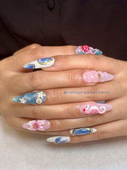 This view of the ocean-themed nails shows the incredible detail on each finger, including the textured seashell nail and the tiny starfish accents.