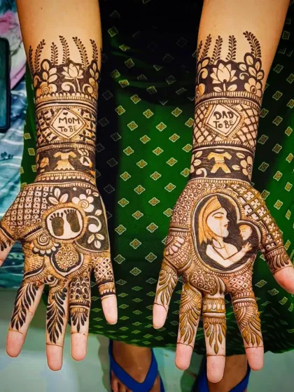 A close-up of a detailed baby shower design. One hand features a portrait of a mother holding her baby, while the other has tiny footprints and "Mom To Be" and "Dad To Be" hearts.