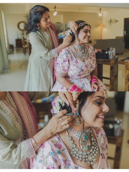 A mother helps her daughter with her hair on her wedding day. These gentle, loving moments between family are priceless.