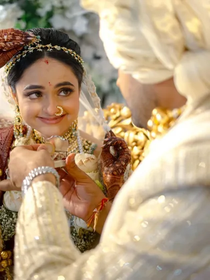 The mangalsutra moment. The groom's hands, the bride's trusting gaze, a memory etched forever.