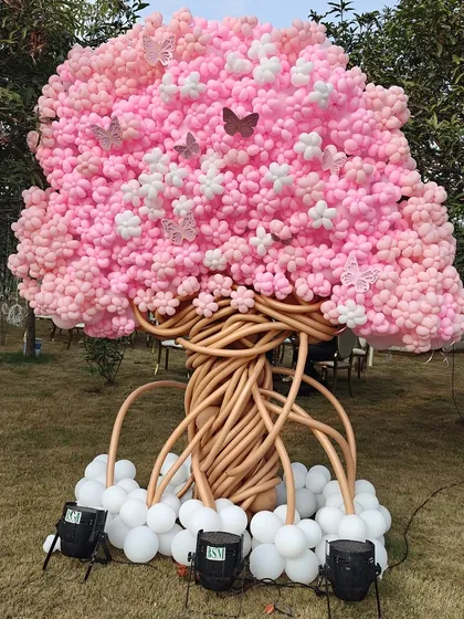 A true work of art: a magnificent cherry blossom tree made entirely of balloons. This incredible sculpture, with its intricate trunk and canopy of pink and white blossoms, is a testament to our team's creativity and skill.