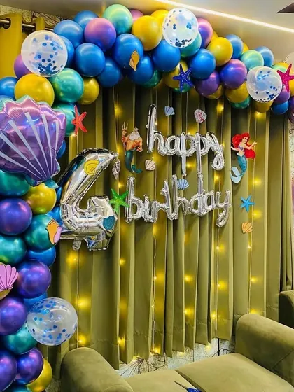A close-up of the mermaid balloon arch, showcasing the mix of metallic colors and themed foil balloons.