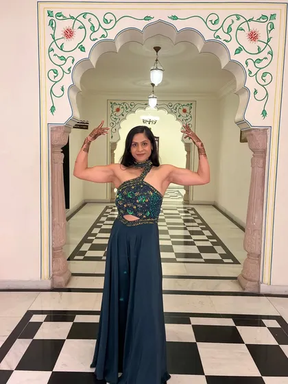 A front double bicep flex, complete with mehendi. You can be strong and feminine at the same time.