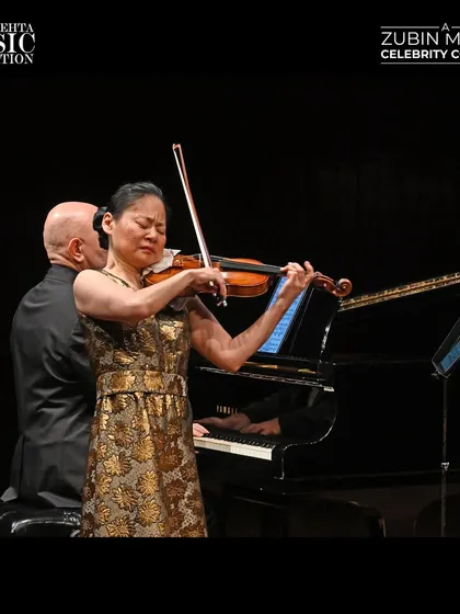 Another angle of Midori's captivating performance, highlighting her expressive playing and the emotional depth she brings to the music.