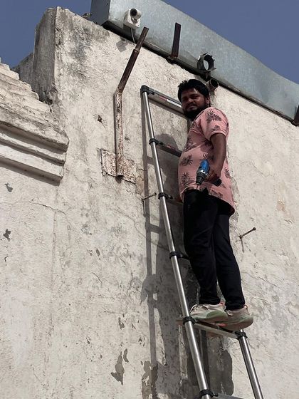 Posing for a moment during a high-up installation. We are confident in our ability to tackle any installation challenge.