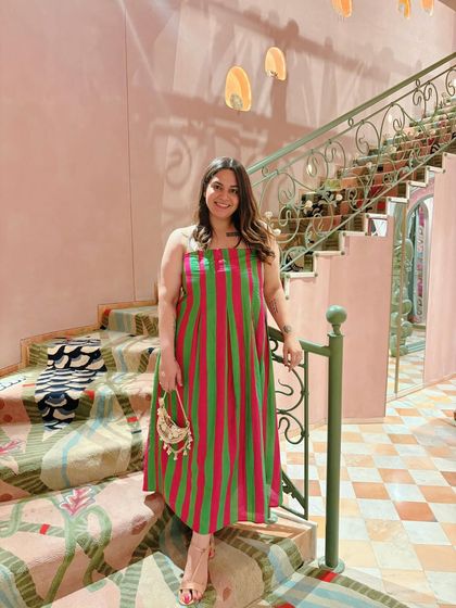 Wearing a striped dress at the Papa Don't Preach store launch. The store is a maximalist dream, and I chose an outfit with a pop of color to match the vibrant, girly-girl energy.