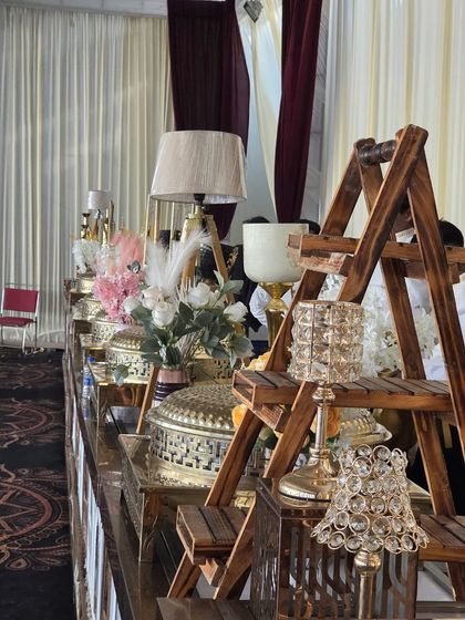 We use a mix of textures and elements like wood, crystal, and florals to create a visually rich buffet landscape. This setup for a wedding reception highlights our attention to decorative detail.