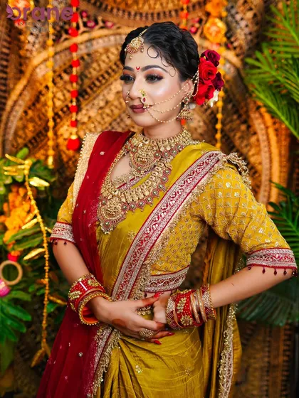 This three-quarter view shows the rich texture of the saree and the intricate details of the temple jewelry, all part of creating an authentic look.