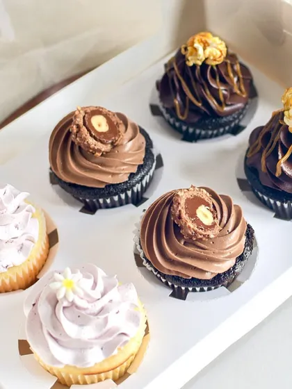 An assorted box of my custom cupcakes. This box includes Lemon & Berry, Nutella with Ferrero Rocher, and Salted Caramel Popcorn flavors, perfect for a party.