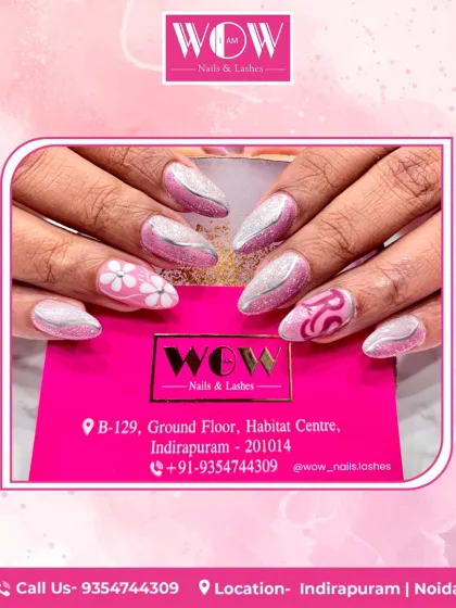 A playful and artistic set of almond-shaped extensions. This design combines glittery silver with pink accents, featuring delicate floral and initial details for a personalized touch.