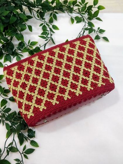 This angled view highlights the rich texture and shimmer of the gold thread against the deep maroon. It’s a handcrafted piece designed to be both beautiful and durable.