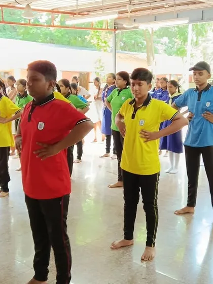 School children learning simple standing asanas to improve their posture and body awareness. Our goal is to make Yoga fun and accessible for every child.