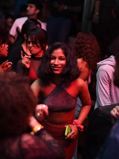 A close-up of a partygoer smiling and dancing.