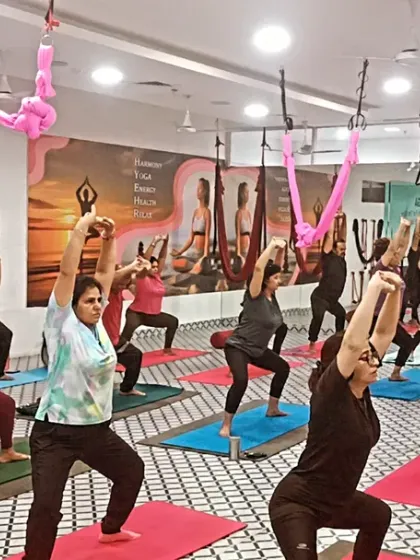 The group moves into a powerful Goddess Pose, building strength and endurance in their legs. The synchronized movement creates a powerful collective energy.