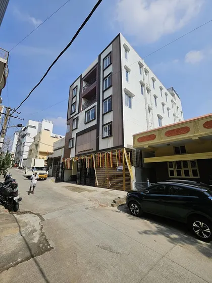 Another view of the Srirampura mixed-use building, showcasing the clean architectural lines and material contrast from a different angle.