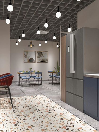For this factory office cafeteria, we used a bold and modern design. The space features a mix of terrazzo, a striking blue and red color scheme, and an industrial grid ceiling to create a vibrant and energetic place for employees to relax.