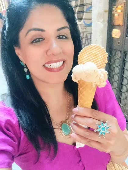 I love playing with bold colour combinations. For my trip to Italy, I paired a bright purple linen dress with a turquoise necklace, earrings, and a statement ring for a fun, vibrant look.