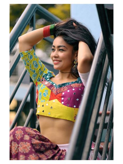 A candid, happy moment captured on a staircase. The natural pose and genuine smile make this portrait feel authentic and full of life.