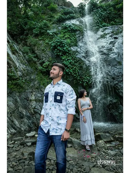 Posing against a stunning waterfall, this shot captures the power and beauty of nature. It's a perfect backdrop for a couple with an adventurous spirit.