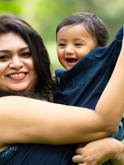 A joyful, candid moment between a mother and her son during their outdoor family session. His laughter is absolutely priceless.