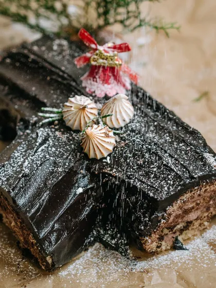 A festive shot of our Christmas Yule Log, dusted with powdered sugar like freshly fallen snow. It's a traditional holiday dessert that we love to make every year.