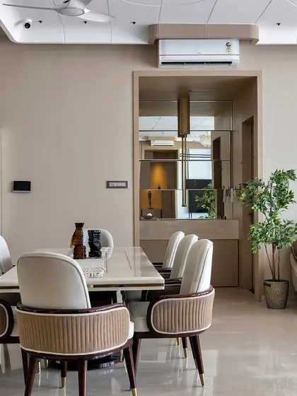 An overview of a modern living and dining area, showing how I create a cohesive look with a neutral color palette, statement lighting, and comfortable, well-proportioned furniture.